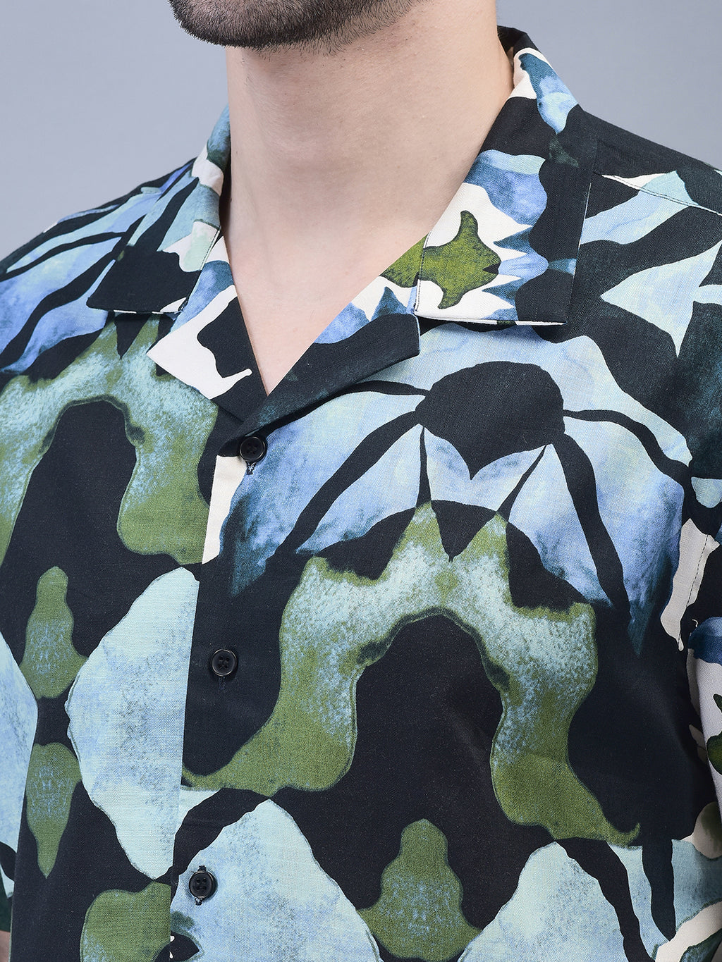 Close-up of camp collar and abstract print – green, black, and white cotton fabric