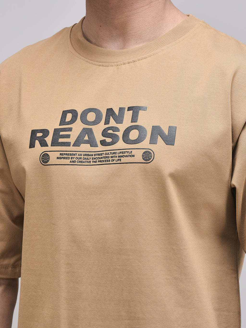 Don’t Reason puff print close-up on brown cotton fabric