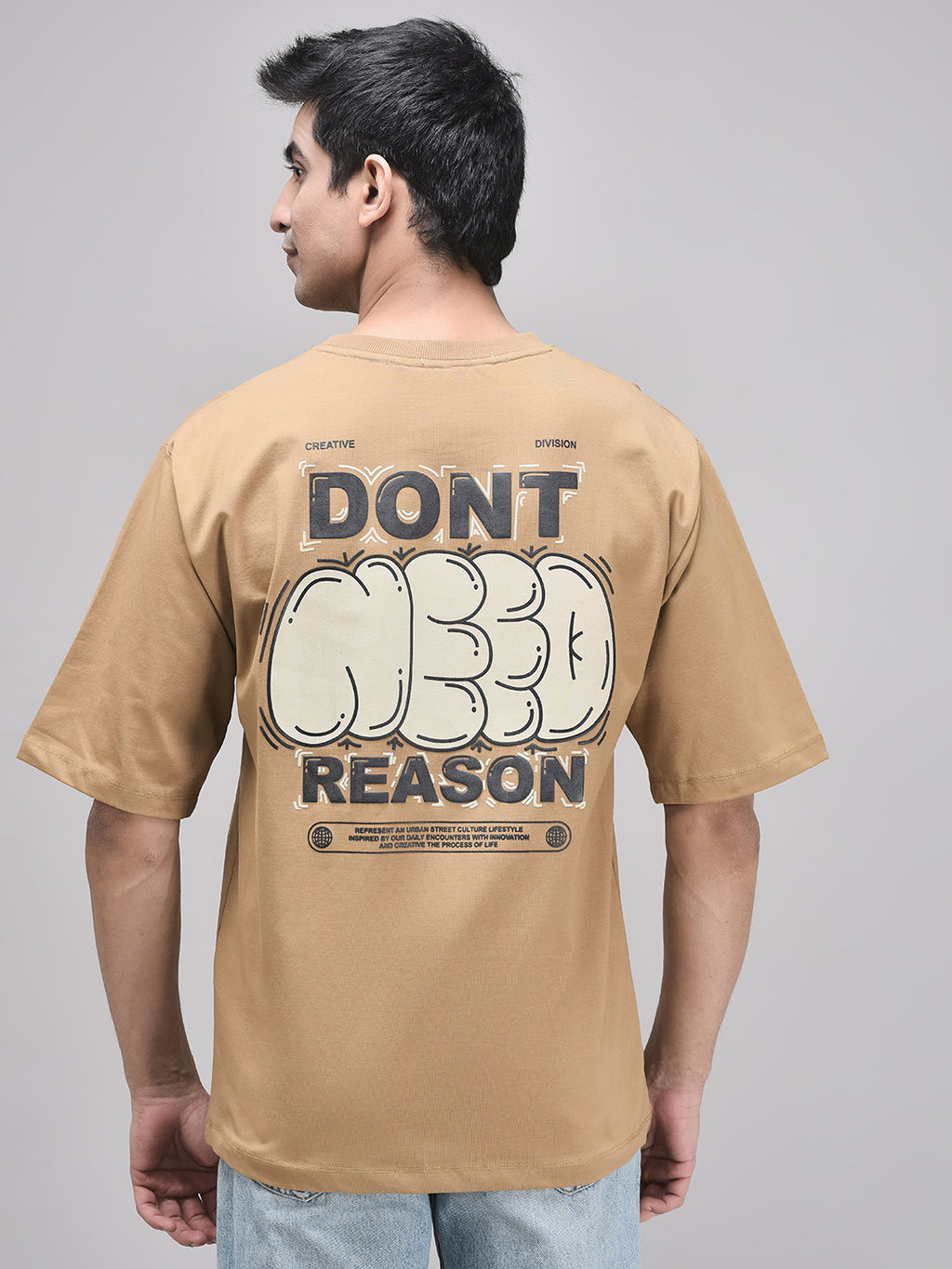 Back view of oversized brown t-shirt with Don’t Reason puff print