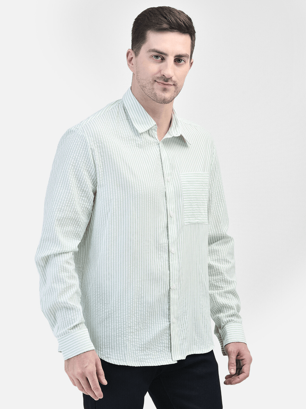 Green cotton shirt worn by man – relaxed fit, front angle view