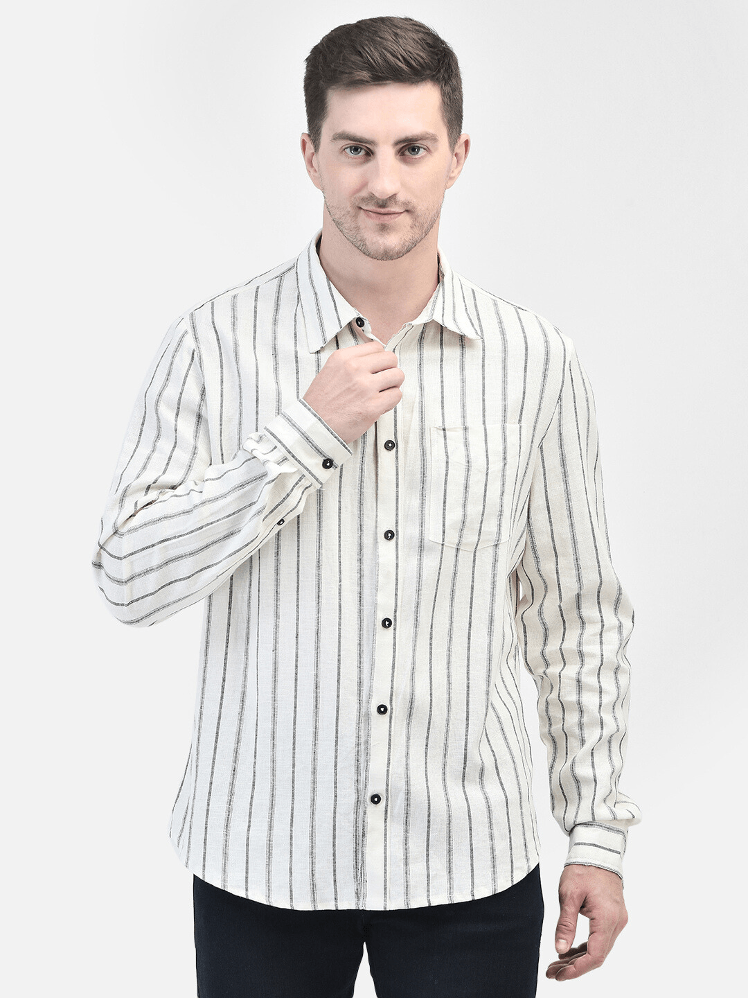 Model wearing a white creme long-sleeve shirt with black vertical stripes, styled with black jeans. Men's White Creme Shirt with Black Stripes | Classic Long-Sleeve Style
Elevate your wardrobe with this classic white cream shirt featuring black vertical stripes. Perfect for both casual and formal occasions, this long-sleeve shirt offers a timeless look.
Keywords: men's white cream shirt, black stripe shirt, long-sleeve shirt, vertical stripes, classic men's fashion, formal casual wear. white striped shirt