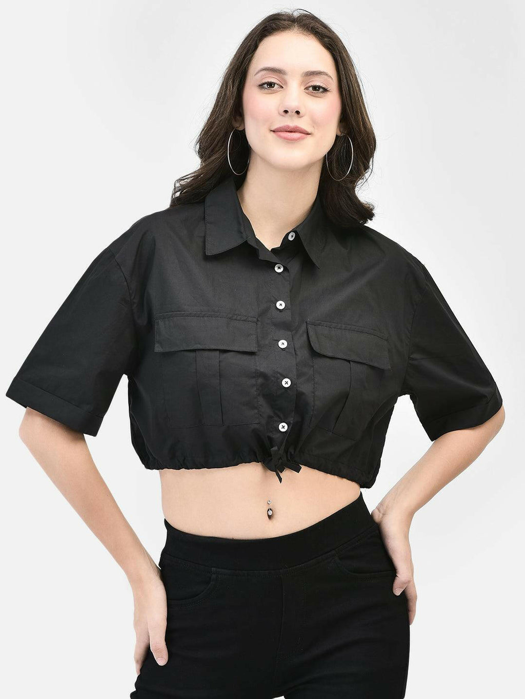 Model posing confidently in midriff-length black cotton crop shirt
