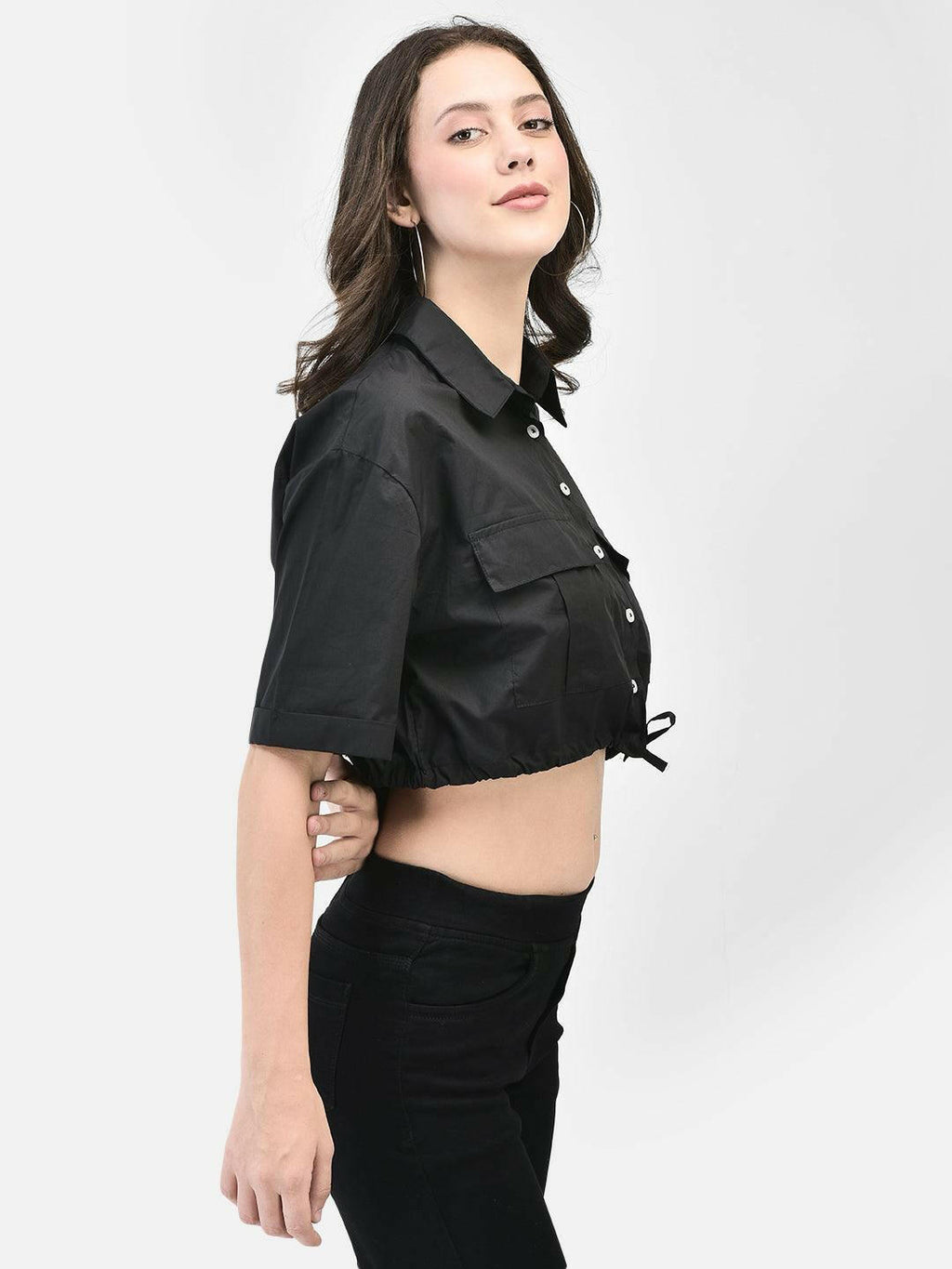Model showcasing the cropped hem and short sleeves in black shirt