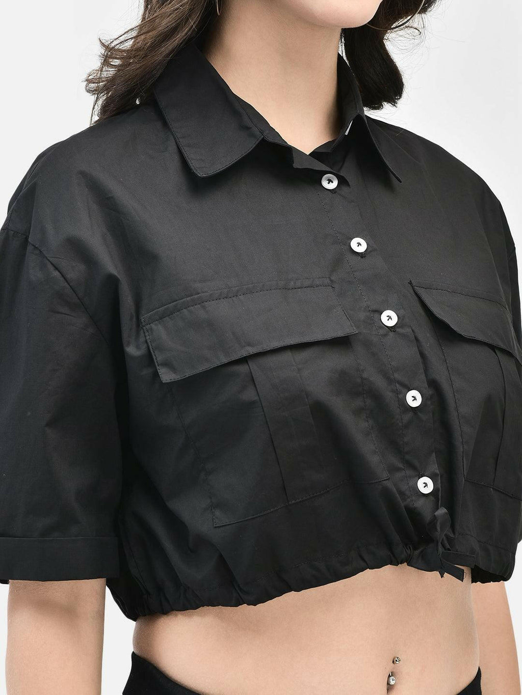Close-up view of shirt's front pockets and buttons in cotton fabric