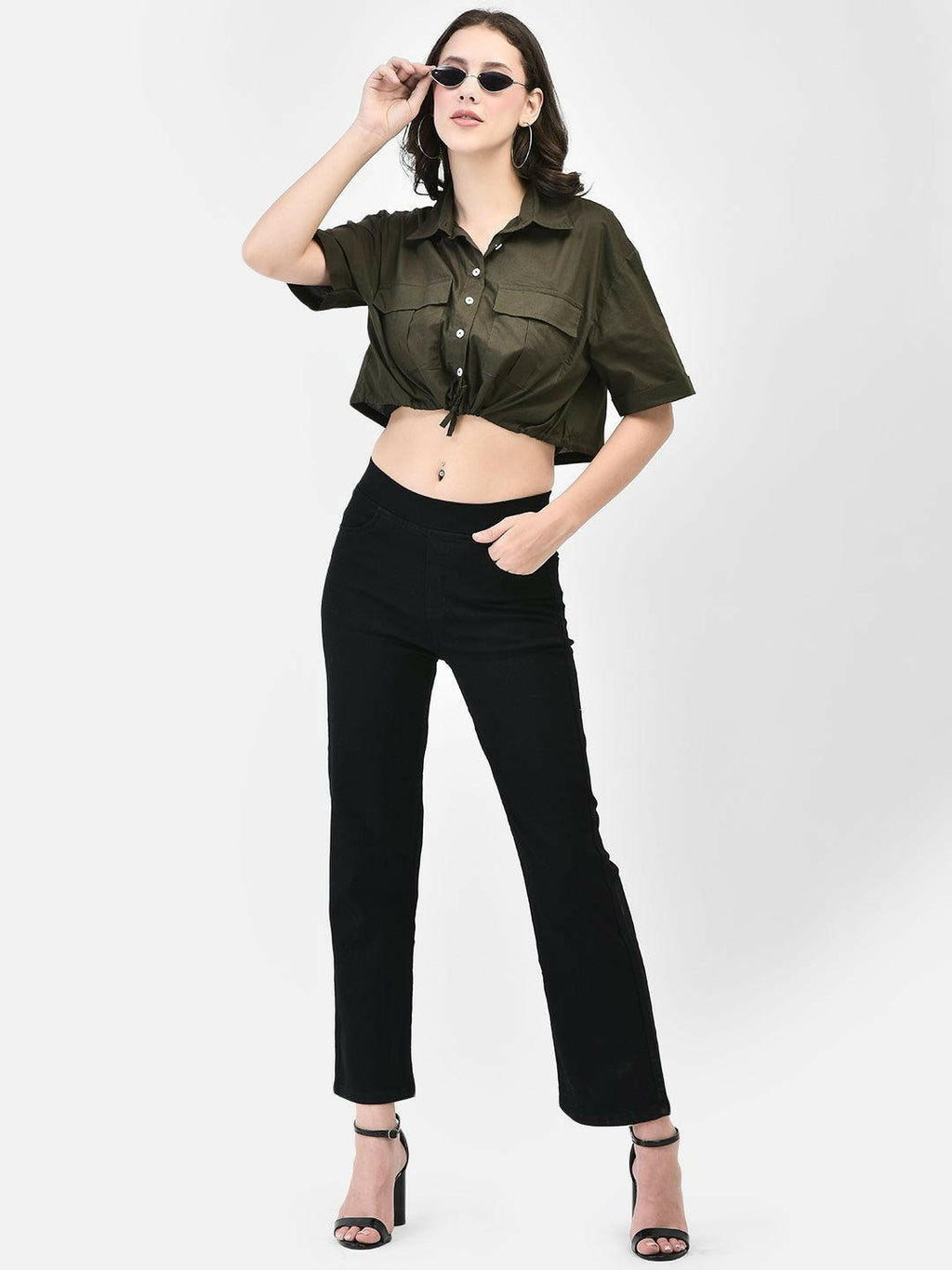 Front-facing image of model wearing olive green cropped cotton shirt and black trousers