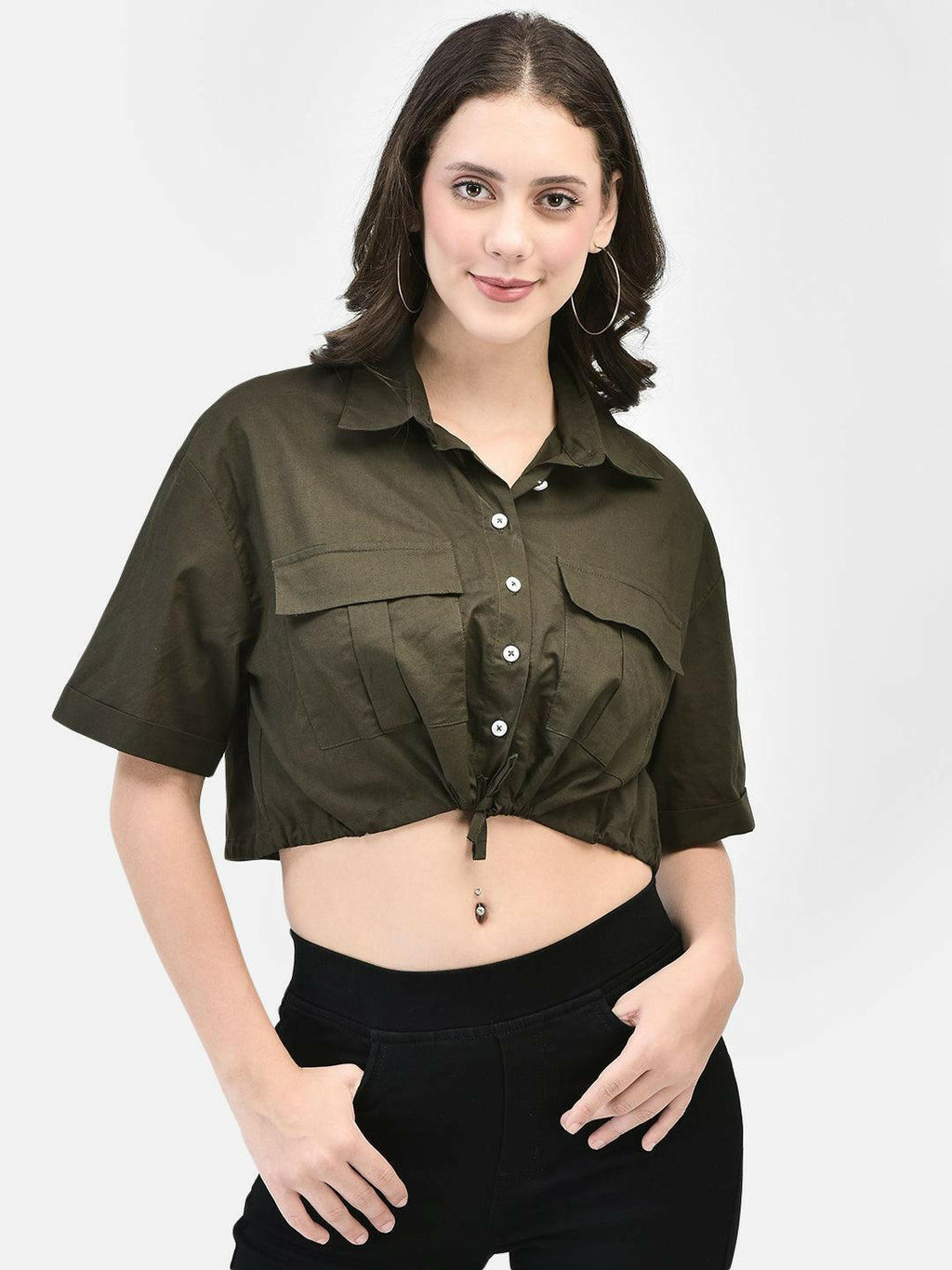 Confident model posing in olive cotton crop shirt with a relaxed fit