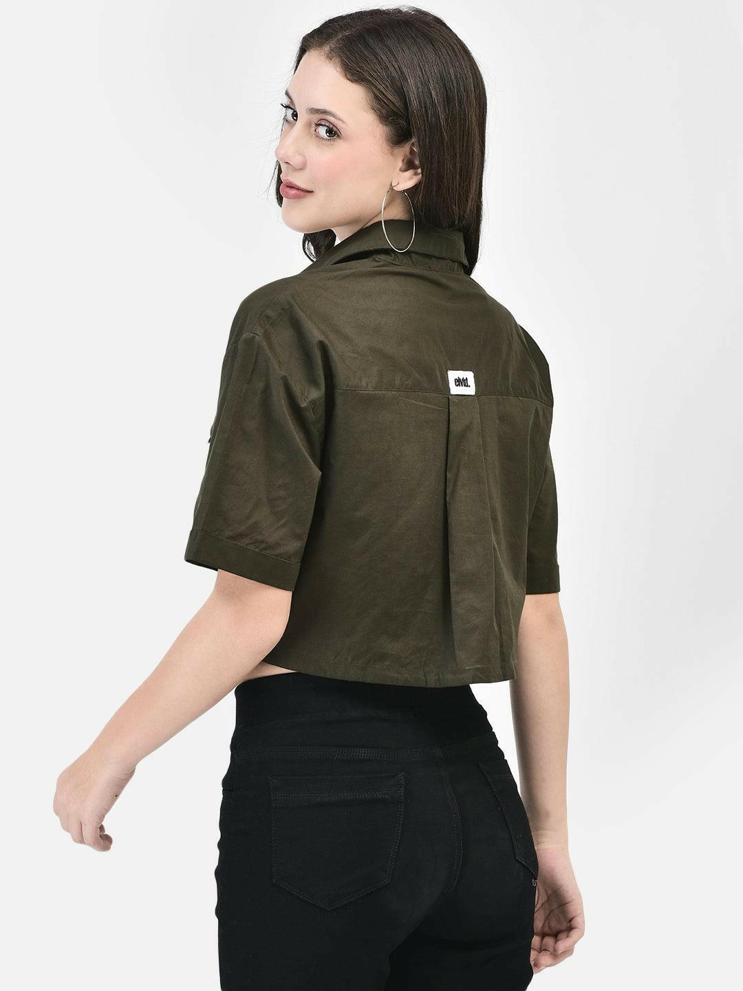 Model wearing a olive colored cropped shirt with front pockets, paired with black high-waisted pants and black heels.
Meta Tags:
Olive Cropped Shirt with Front Pockets | elvtd. Fashion
Elevate your casual look with this Olive Moss cropped shirt featuring front pockets and a stylish tie-front. Perfect for pairing with high-waisted pants for a chic and modern outfit.
Keywords: Olive moss cropped shirt, front pocket shirt, women's casual shirt, tie-front shirt, olive fashion top 