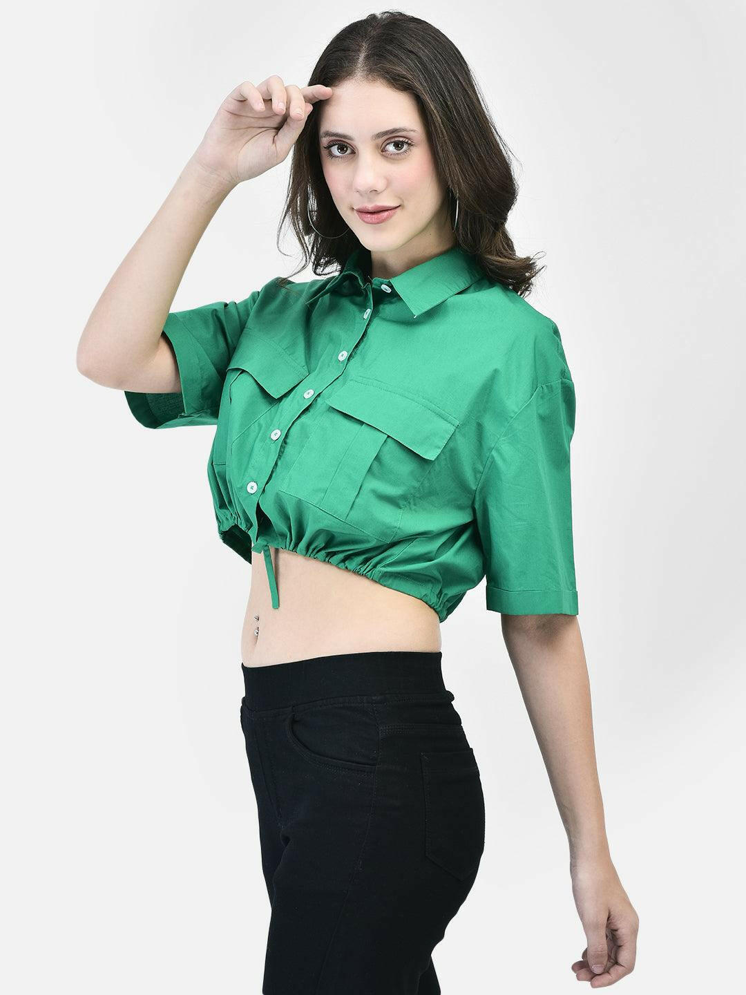 Model wearing a green cropped shirt with front pockets, paired with black high-waisted pants and beige heels.
Meta Tags:
Green Cropped Shirt with Front Pockets | elvtd. Fashion
Elevate your casual look with this green cropped shirt featuring front pockets and a stylish tie-front. Perfect for pairing with high-waisted pants for a chic and modern outfit.
Keywords: Green cropped shirt, front pocket shirt, women's casual shirt, tie-front shirt, green fashion top