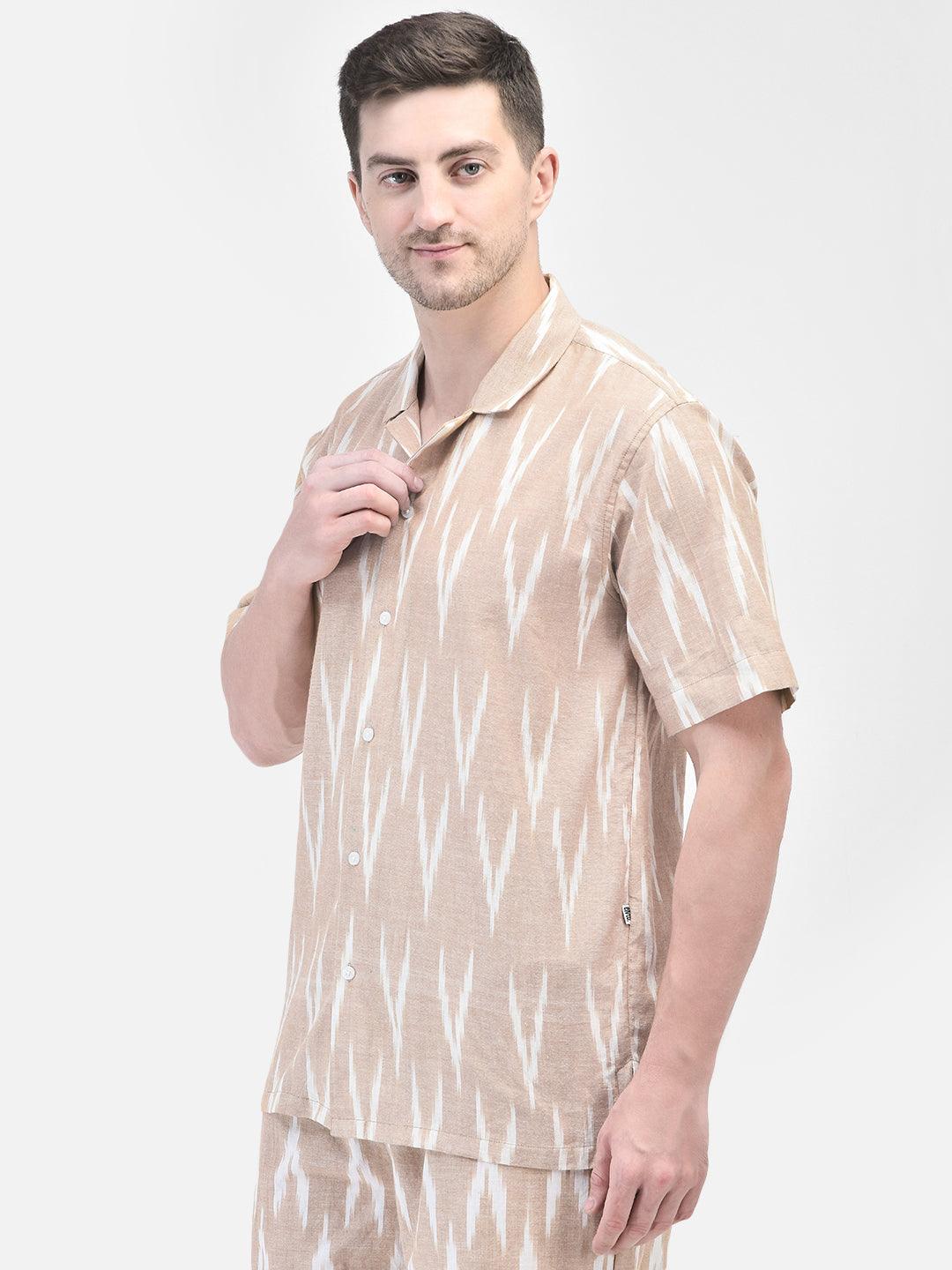 Man wearing beige and white patterned co-ord set with matching shirt and shorts by elvtd. Meta Tags and Keywords: Men's Co-ord Set, Summer Outfit, Casual Wear, Beachwear, elvtd. Fashion. men's co-ord set, beige and white patterned outfit, matching shirt and shorts, summer fashion, casual summer outfit, elvtd. men's wear, stylish men's outfit, beachwear, summer wardrobe essentials