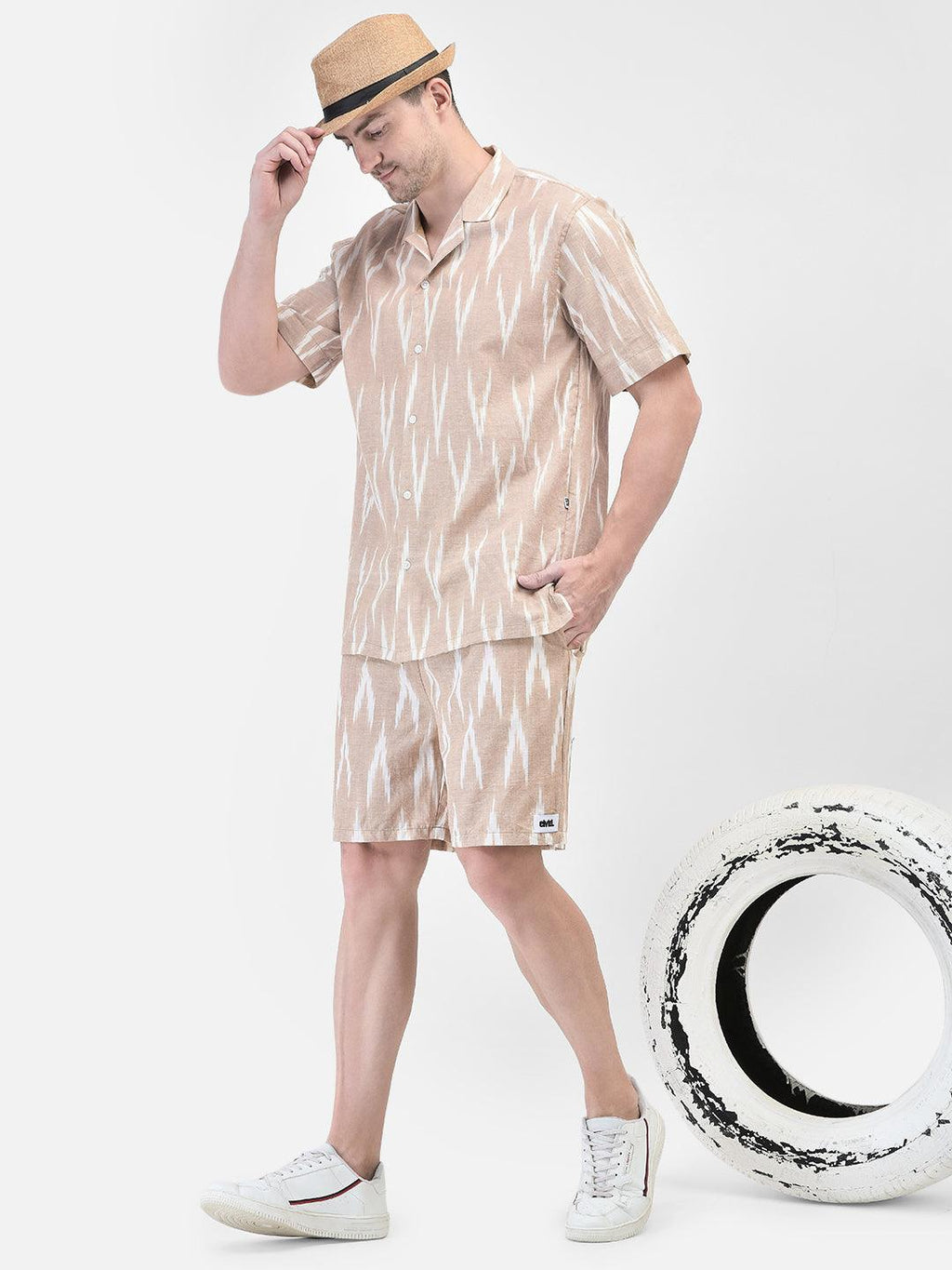 Alt Text: Man wearing beige and white patterned co-ord set with matching shirt and shorts by elvtd. Meta Tags and Keywords: Men's Co-ord Set, Summer Outfit, Casual Wear, Beachwear, elvtd. Fashion. men's co-ord set, beige and white patterned outfit, matching shirt and shorts, summer fashion, casual summer outfit, elvtd. men's wear, stylish men's outfit, beachwear, summer wardrobe essentials