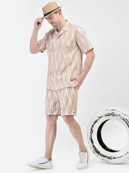 Alt Text: Man wearing beige and white patterned co-ord set with matching shirt and shorts by elvtd. Meta Tags and Keywords: Men's Co-ord Set, Summer Outfit, Casual Wear, Beachwear, elvtd. Fashion. men's co-ord set, beige and white patterned outfit, matching shirt and shorts, summer fashion, casual summer outfit, elvtd. men's wear, stylish men's outfit, beachwear, summer wardrobe essentials