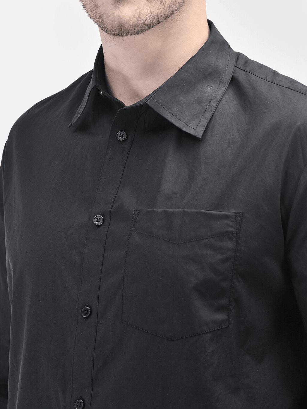 Close-up of shirt collar and chest pocket of black premium cotton shirt
