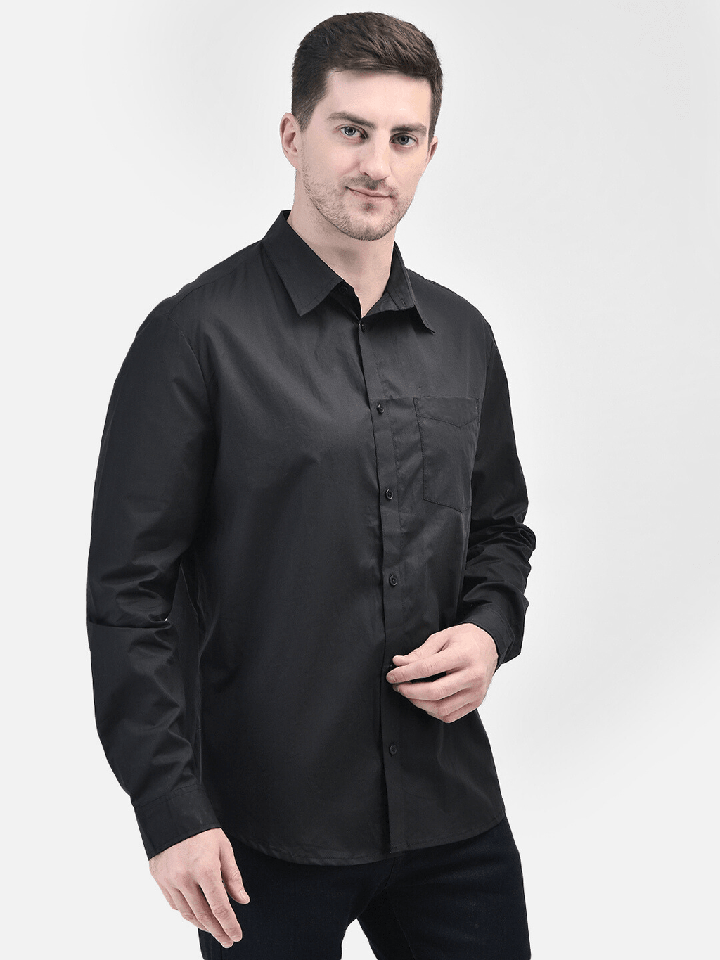 Side angled view of black shirt for men styled with formal pants
