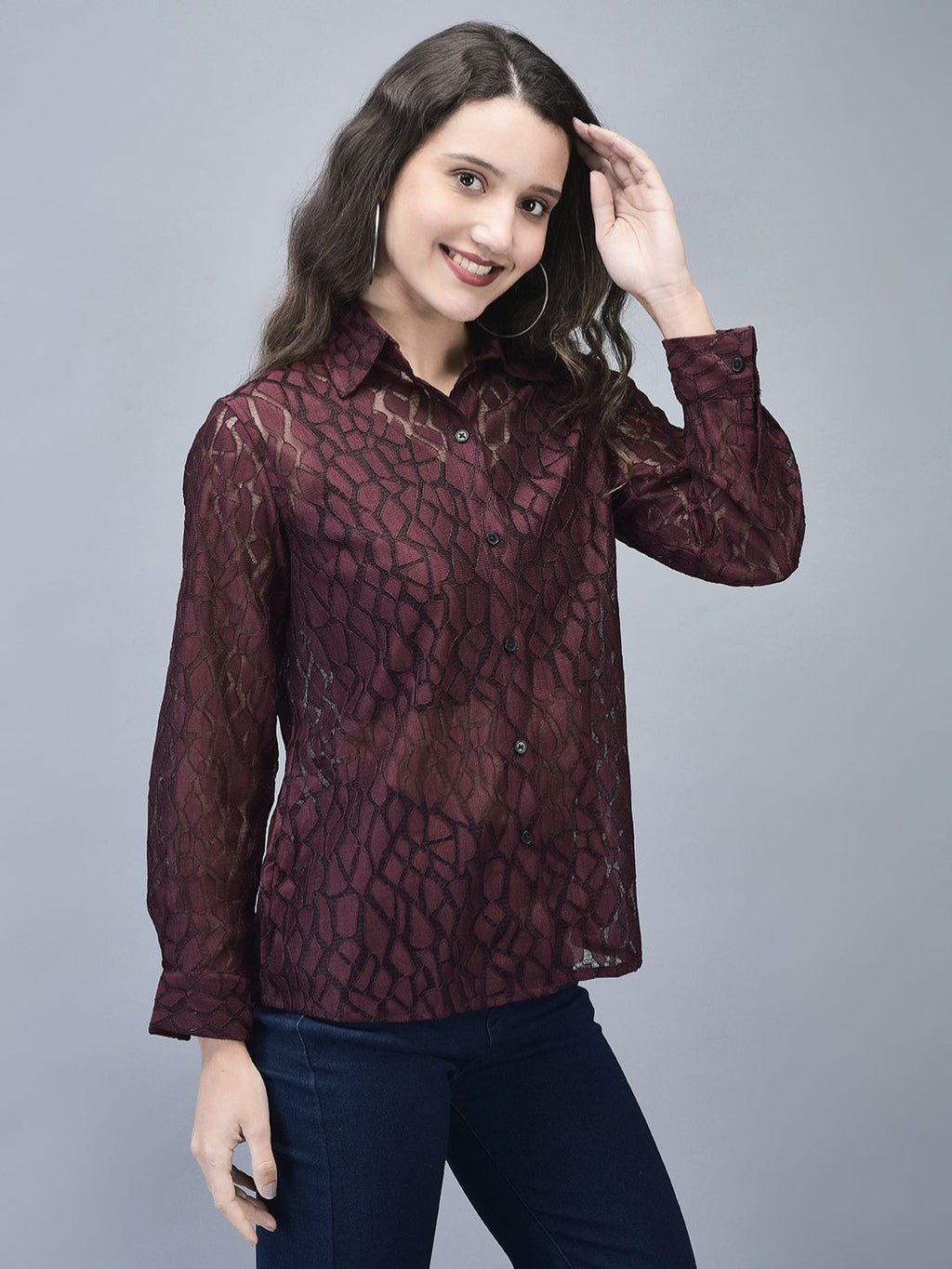Side angled shot of woman in wine full-sleeve crochet shirt smiling
