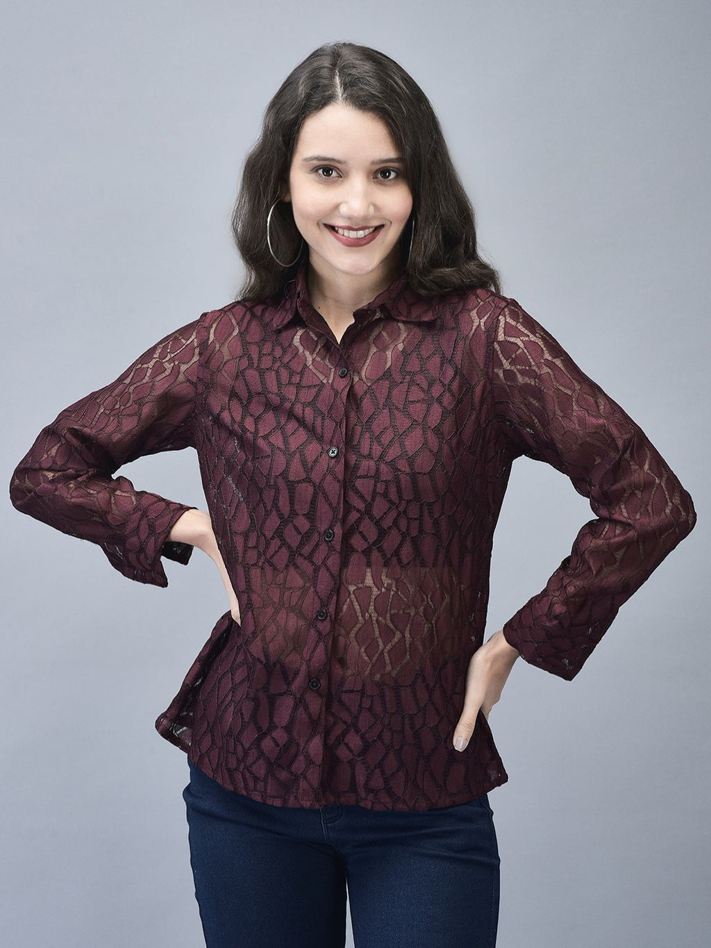 Woman posing with hand on head in wine textured shirt, full front view